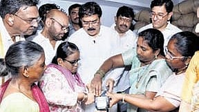 Minister Nadendla Manohar distributes ration to beneficiaries in Kakinada.