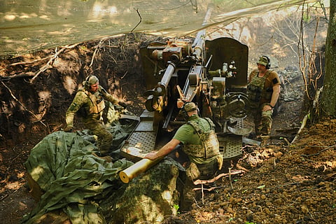 In this photo provided by Ukraine's 127th Separate Brigade of the Territorial Defence press service, soldiers fire a canon towards Russian army positions near Kharkiv, Ukraine, Monday, June 2, 2025,