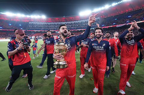 Virat Kohli and his teammates celebrate their IPL triumph at the Narendra Modi Stadium in Ahmedabad on Tuesday