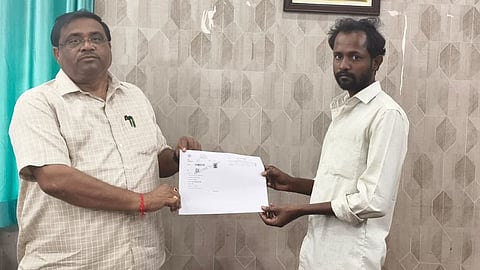 Anil Kumar receiving land documents from Patancheru Tahasildar on Wednesday.