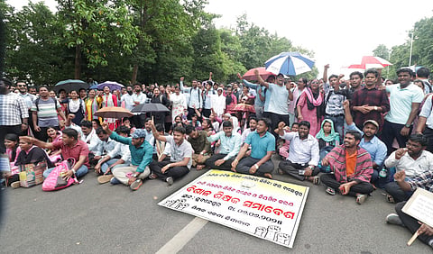 Odisha  Junior Teacher Association members staging dharna demanding regular job at Mahatma Gandhi Marg in Bhubaneswar.