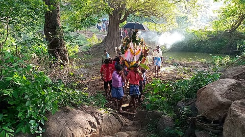 Villagers carry the body of a six-year-old boy on a doli to the cremation ground on Tuesday 