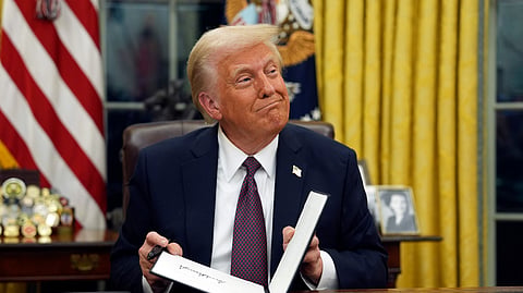 US President Donald Trump signs executive orders in the Oval Office of the White House, Jan. 20, 2025, in Washington. 