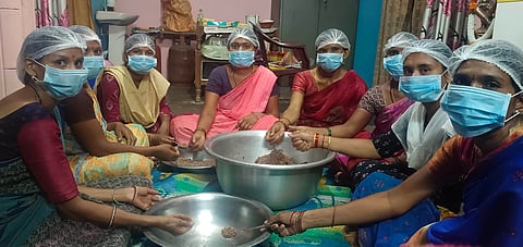 Members of the Muthyalamma Joint Liability Group are preparing laddus using mahua flowers
