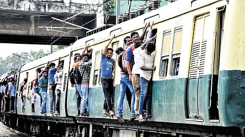 Following the bus transport strike local trains in Chennai witnessed huge crowd during the peek hours. Passengers are seen hanging on the footboard in a local train near Kodambakkam Railway Station. 