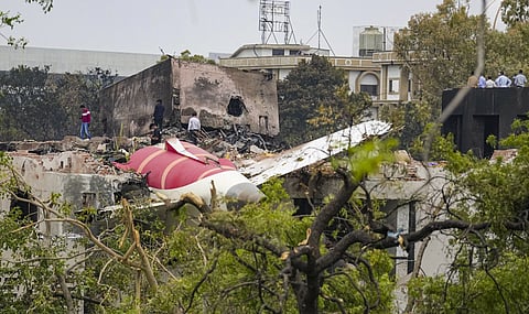 Remains of the crashed Air India plane lie on a building, in Ahmedabad, Friday, June 13, 2025. 