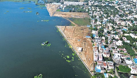 An aerial shot of Madambakkam lake shows buildings on the banks of the waterbody 