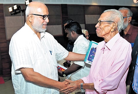 CPM general secretary M A Baby interacting with M K Sanoo during a book launch in Kochi on Saturday  