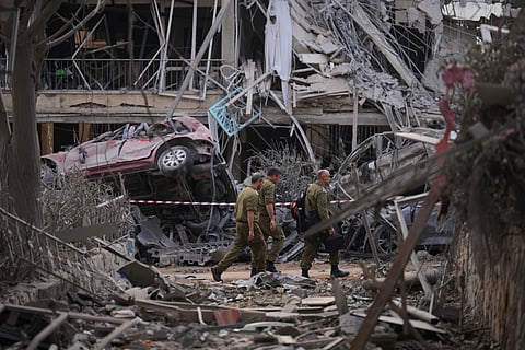 Israeli security forces inspect destroyed residential buildings that were hit by a missile fired from Iran, in Ramat Gan, near Tel Aviv, Israel, on Saturday, June 14, 2025. 