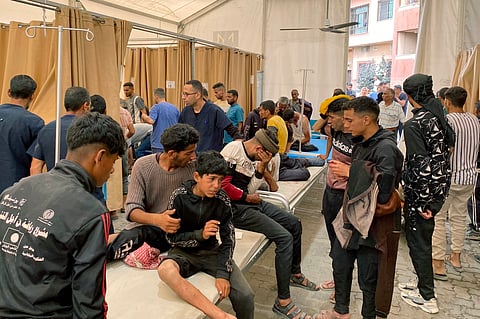 Palestinians who were injured in Israeli fire as they gathered near a food aid centre, receive care at Khan Yunis' Nasser hospital in the southern Gaza Strip on June 17, 2025. 