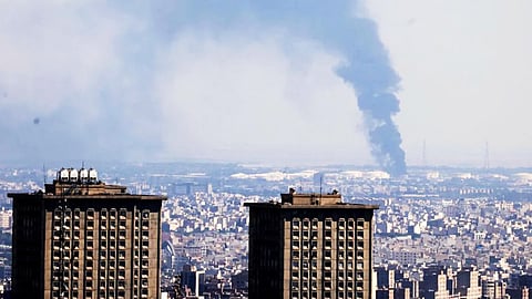 Smoke billows in the distance from an oil refinery following an Israeli strike on the Iranian capital Tehran on Tuesday. 