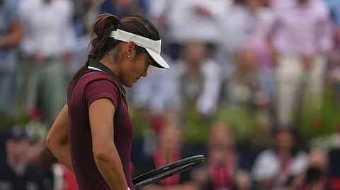 Britain’s Emma Raducanu reacts after losing to China’s Zheng Qinwen in a women’s singles quarterfinal match at the Queens Club grass court tennis championships in London, Friday, June 13, 2025. 