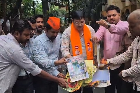  MNS party workers seen burning Hindi textbooks as a mark of protest