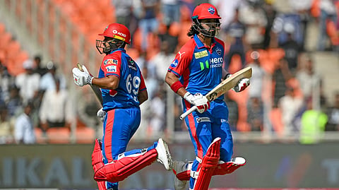 Delhi Capitals' KL Rahul (R) and Karun Nair run between the wickets during the IPL Twenty20 cricket match between Gujarat Titans and Delhi Capitals at the Narendra Modi Stadium in Ahmedabad on April 19, 2025. 