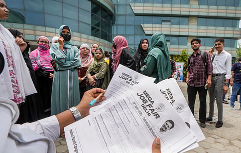  A volunteer checks the application forms collected at a 'Mega Job Fair', organised by Indian Youth Congress on the birthday of LoP in the Lok Sabha and Congress leader Rahul Gandhi, at Talkatora Stadium in New Delhi, Thursday, June 19, 2025. 