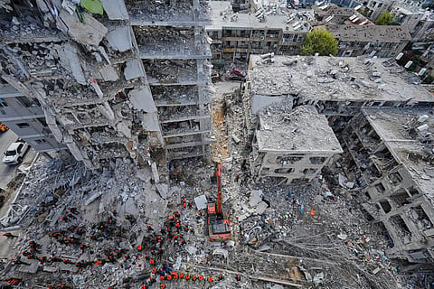 Israeli soldiers search through the rubble of residential buildings destroyed by an Iranian missile strike in Bat Yam, central Israel, on Sunday, June 15, 2025. 
