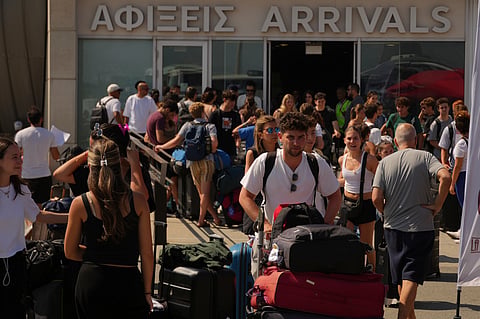 Evacuees from Israel arrive at Cyprus' main port of Limassol aboard the cruise ship Crown Iris, on Saturday, June 21, 2025. 