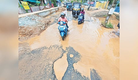 Motorists negotiate a difficult stretch on the Tirumala-Thrikkannapuram road riddled with enormous potholes 