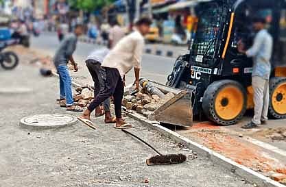 Workers clearing construction debris without proper safety gear in Chennai 