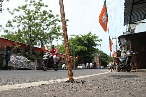 Temporary flagpoles were placed by members of a political party after damaging the newly laid road on Rodiyar Mill Street, Mudaliyarpet, Pondicherry
