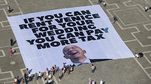 This photo released by Greenpeace shows a large banner against Amazon founder Jeff Bezos' planned wedding, in St. Mark Square, in Venice, Italy Monday, June 23, 2025. 