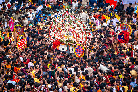 Sevayats pulling Lord Balabhadra to the chariot in Pahandhi Bije at Puri on the occasion of the annual Ratha Yatra on Friday. 