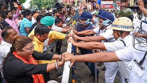 BJP activists clash with police personnel during their protest against the alleged gang-rape of a girl student of a law college, in Kolkata, West Bengal, Saturday, June 28, 2025. 