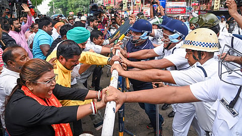 BJP activists clash with police personnel during their protest against the alleged gang-rape of a girl student of a law college, in Kolkata, West Bengal, Saturday, June 28, 2025. 