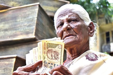 G Thangamani shows the old currency notes 