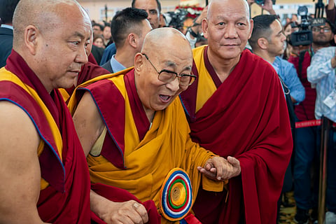 Attendant monks help Tibetan spiritual leader the Dalai Lama to leave after presiding over an event celebrating his 90th birthday according to a Tibetan calendar at the Tsuglakhang temple in Dharamshala, India, Monday, June 30, 2025, ahead of his birthday according to the Gregorian calendar on July 6. 