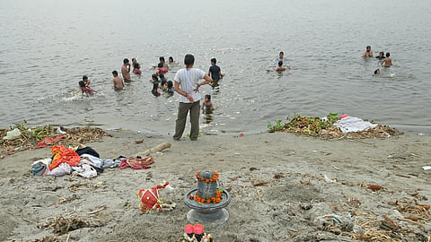 Devotees take a holy dip in the Yamuna River at Jagatpur Ghat 