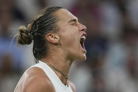 Aryna Sabalenka of Belarus reacts after winning a point against Emma Raducanu of Britain during a third round women's singles match at the Wimbledon Tennis Championships in London, Friday, July 4, 2025.
