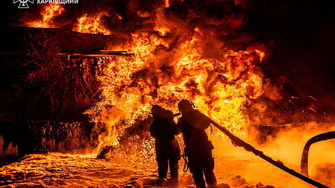In this photo provided by the Ukrainian Emergency Service, emergency services personnel work to extinguish a fire following a Russian attack in Kharkiv region, Ukraine, Saturday, July 5, 2025