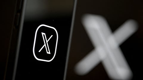 This illustration photograph shows the logo of social network X (formerly Twitter) displayed on a smartphone