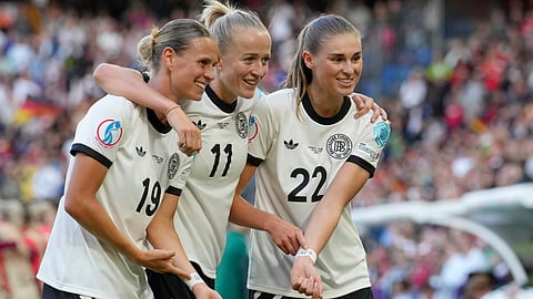 Germany's Lea Schueller, centre, celebrates with Klara Buehl, left, and Jule Brand after scoring her side's second goal during the Euro 2025, group C, soccer match between Germany and Denmark on July 8, 2025. 