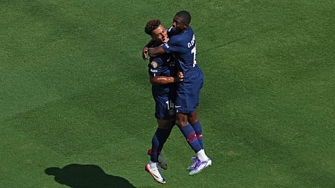 PSG's Ousmane Dembele (R) celebrates scoring his team's second goal with Desire Doue during the FIFA Club World Cup 2025 semifinal football match between PSG and Real Madrid on July 9, 2025. 
