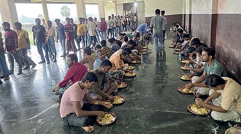 The detainees having food at a holding centre in Jharsuguda 
