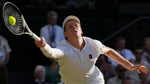 Italy's Jannik Sinner returns to Serbia's Novak Djokovic in a men's singles semifinal at the Wimbledon Tennis Championships in London, Friday, July 11, 2025. 