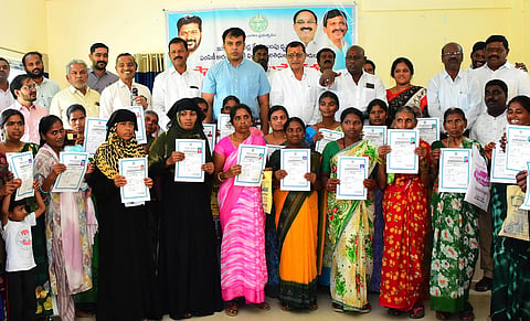 Beneficiaries of the Indiramma housing scheme display their patta certificates  