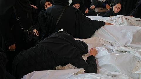 Mourners attend the funeral of their relatives who were killed in an Israeli bombardment, in Deir al-Balah, Gaza Strip, Saturday, July 12, 2025. 