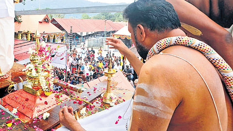 Thantri Kandararu Rajivaru performs pooja on the ‘thazhikakkudam’ of the newly-built ‘Navagraha’ temple at Sabarimala on Sunday 
