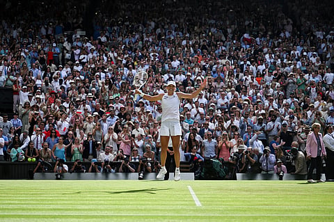 Poland's Iga Swiatek celebrates after winning against US player Amanda Anisimova during their women's singles final tennis match at the 2025 Wimbledon Championships at The All England Lawn Tennis and Croquet Club in Wimbledon, southwest London, on July 12, 2025.