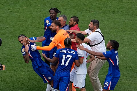 Chelsea's Joao Pedro, left, is attacked by Paris Saint-Germain's goalkeeper Gianluigi Donnarumma and coach Luis Enrique at the end of the Club World Cup final soccer match between Chelsea and PSG on  July 13, 2025. 