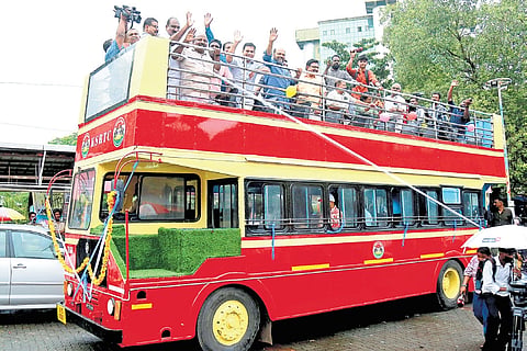 Industries Minister P Rajeeve greeting passengers after flagging off the KSRTC open-top double-decker bus at Ernakulam boat jetty on Tuesday. MP Hibi Eiden, MLA T J Vinod and Mayor M Anilkumar are also seen 