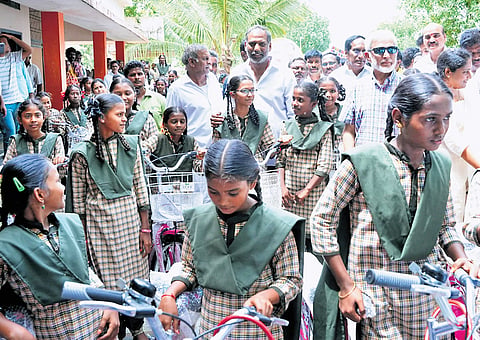 Energy Minister Gottipati Ravi Kumar distributed bicycles to students at the Addanki government school on Tuesday 