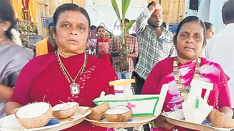 Koli men and women from Mumbai hold miniature replicas of their boats while offering prayer for safety at sea at a church in Velankanni 