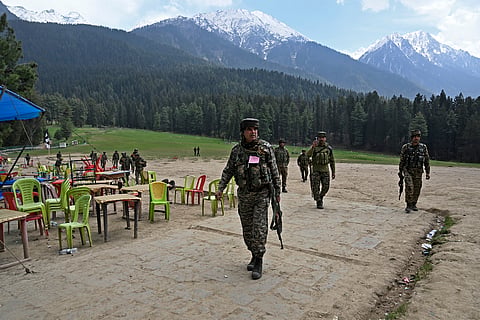 Security personnel inspect the site in the aftermath of an attack as food stall chairs lie empty in Pahalgam, about 90km (55 miles) from Srinagar on April 23, 2025. 