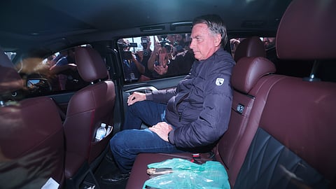 Brazil's former President Jair Bolsonaro leaves the Secretariat of Penitentiary Administration where he arrived after the Supreme Court ordered him to be fitted with an electronic ankle monitor in Brasilia, Brazil, Friday, July 18, 2025.