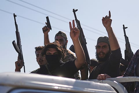 Bedouin fighters stand on a pickup truck as they arrive at al-Dour village on the outskirts of Sweida city.
