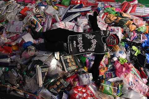 A person in plastic devil attire creates awareness on usage of single use plastic during a meeting organised as a part of Swachh Andhra campaign.